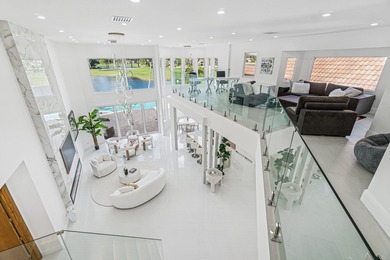 A striking, newly renovated two-story residence showcasing on Polo Club of Boca Raton in Florida - for sale on GolfHomes.com, golf home, golf lot