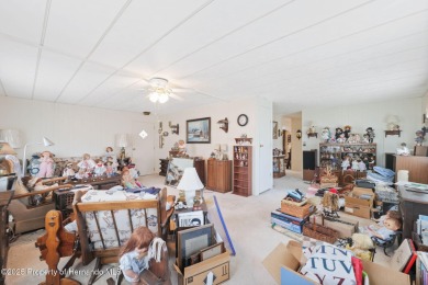 This 2 bedroom, 2 bath home with a covered carport wraps you in on High Point Golf Club, Inc. in Florida - for sale on GolfHomes.com, golf home, golf lot