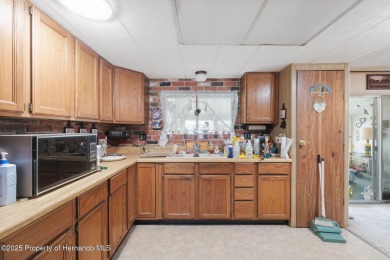 This 2 bedroom, 2 bath home with a covered carport wraps you in on High Point Golf Club, Inc. in Florida - for sale on GolfHomes.com, golf home, golf lot
