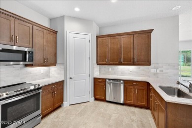 The Arbor II Townhome features a low-maintenance design with a on Plantation Bay Golf and Country Club in Florida - for sale on GolfHomes.com, golf home, golf lot