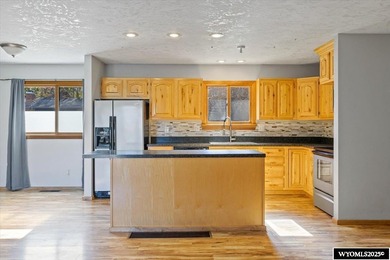 Enjoy golf course living in this inviting 3-bedroom, 2-bath on Paradise Valley Country Club in Wyoming - for sale on GolfHomes.com, golf home, golf lot