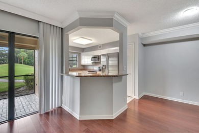 Perfectly located first floor condo residence with long views of on Bocaire Country Club in Florida - for sale on GolfHomes.com, golf home, golf lot