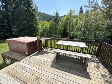 Located on a quiet half-acre lot with 100 feet of Lamb Creek on Priest Lake Golf and Tennis Club in Idaho - for sale on GolfHomes.com, golf home, golf lot