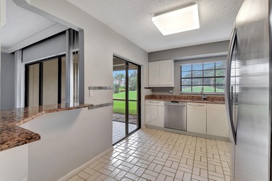 Perfectly located first floor condo residence with long views of on Bocaire Country Club in Florida - for sale on GolfHomes.com, golf home, golf lot