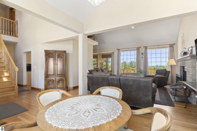 Perched on a quiet hilltop with sweeping views of Bear Lake and on  in Michigan - for sale on GolfHomes.com, golf home, golf lot