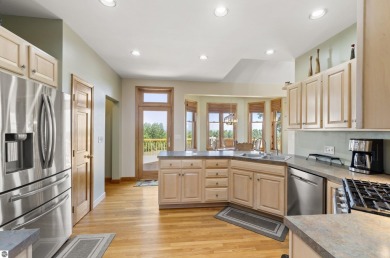 Perched on a quiet hilltop with sweeping views of Bear Lake and on  in Michigan - for sale on GolfHomes.com, golf home, golf lot