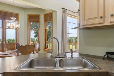 Perched on a quiet hilltop with sweeping views of Bear Lake and on  in Michigan - for sale on GolfHomes.com, golf home, golf lot