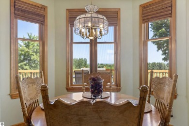 Perched on a quiet hilltop with sweeping views of Bear Lake and on  in Michigan - for sale on GolfHomes.com, golf home, golf lot