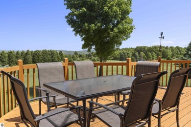 Perched on a quiet hilltop with sweeping views of Bear Lake and on  in Michigan - for sale on GolfHomes.com, golf home, golf lot