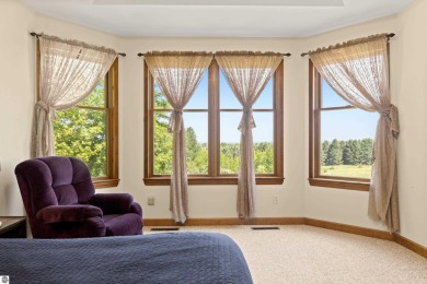 Perched on a quiet hilltop with sweeping views of Bear Lake and on  in Michigan - for sale on GolfHomes.com, golf home, golf lot