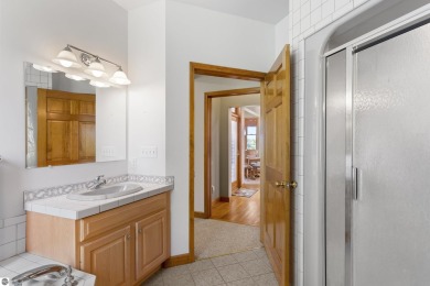 Perched on a quiet hilltop with sweeping views of Bear Lake and on  in Michigan - for sale on GolfHomes.com, golf home, golf lot