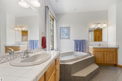 Perched on a quiet hilltop with sweeping views of Bear Lake and on  in Michigan - for sale on GolfHomes.com, golf home, golf lot
