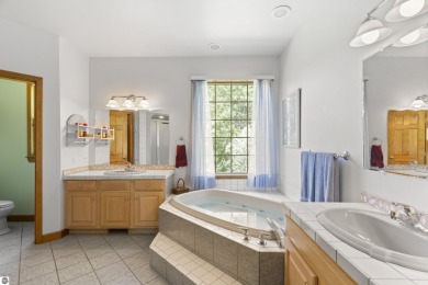 Perched on a quiet hilltop with sweeping views of Bear Lake and on  in Michigan - for sale on GolfHomes.com, golf home, golf lot