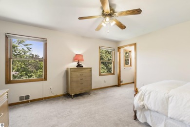 Perched on a quiet hilltop with sweeping views of Bear Lake and on  in Michigan - for sale on GolfHomes.com, golf home, golf lot