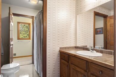 Perched on a quiet hilltop with sweeping views of Bear Lake and on  in Michigan - for sale on GolfHomes.com, golf home, golf lot