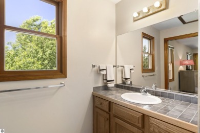 Perched on a quiet hilltop with sweeping views of Bear Lake and on  in Michigan - for sale on GolfHomes.com, golf home, golf lot