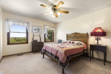 Perched on a quiet hilltop with sweeping views of Bear Lake and on  in Michigan - for sale on GolfHomes.com, golf home, golf lot