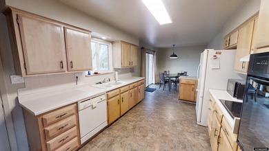 Welcome to this beautiful 3-bedroom, 2-bath tri-level located on on Paradise Valley Country Club in Wyoming - for sale on GolfHomes.com, golf home, golf lot