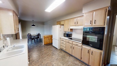 Welcome to this beautiful 3-bedroom, 2-bath tri-level located on on Paradise Valley Country Club in Wyoming - for sale on GolfHomes.com, golf home, golf lot