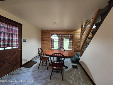 Check out this 3-bedroom, 1-bathroom log home! Featuring a cozy on Rock Creek Golf Course in Pennsylvania - for sale on GolfHomes.com, golf home, golf lot