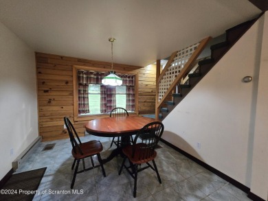 Check out this 3-bedroom, 1-bathroom log home! Featuring a cozy on Rock Creek Golf Course in Pennsylvania - for sale on GolfHomes.com, golf home, golf lot