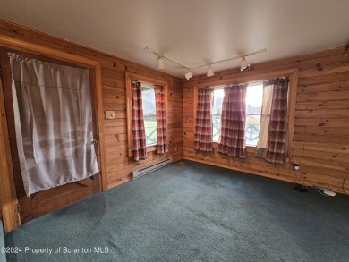 Check out this 3-bedroom, 1-bathroom log home! Featuring a cozy on Rock Creek Golf Course in Pennsylvania - for sale on GolfHomes.com, golf home, golf lot