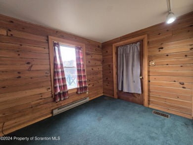 Check out this 3-bedroom, 1-bathroom log home! Featuring a cozy on Rock Creek Golf Course in Pennsylvania - for sale on GolfHomes.com, golf home, golf lot