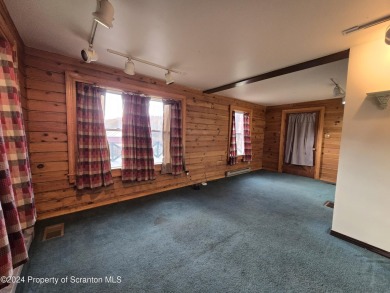 Check out this 3-bedroom, 1-bathroom log home! Featuring a cozy on Rock Creek Golf Course in Pennsylvania - for sale on GolfHomes.com, golf home, golf lot