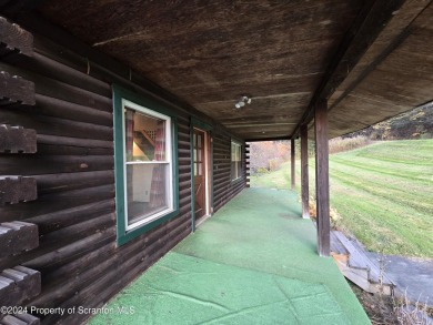 Check out this 3-bedroom, 1-bathroom log home! Featuring a cozy on Rock Creek Golf Course in Pennsylvania - for sale on GolfHomes.com, golf home, golf lot