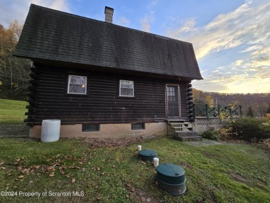 Check out this 3-bedroom, 1-bathroom log home! Featuring a cozy on Rock Creek Golf Course in Pennsylvania - for sale on GolfHomes.com, golf home, golf lot