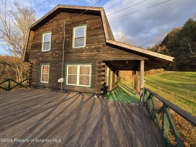 Check out this 3-bedroom, 1-bathroom log home! Featuring a cozy on Rock Creek Golf Course in Pennsylvania - for sale on GolfHomes.com, golf home, golf lot