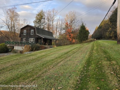 Check out this 3-bedroom, 1-bathroom log home! Featuring a cozy on Rock Creek Golf Course in Pennsylvania - for sale on GolfHomes.com, golf home, golf lot