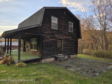 Check out this 3-bedroom, 1-bathroom log home! Featuring a cozy on Rock Creek Golf Course in Pennsylvania - for sale on GolfHomes.com, golf home, golf lot