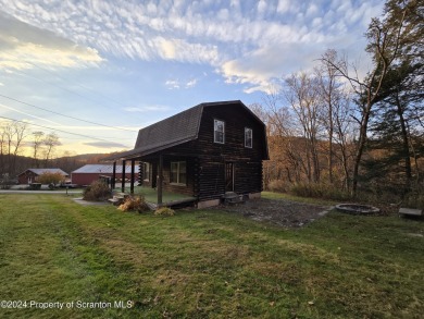 Check out this 3-bedroom, 1-bathroom log home! Featuring a cozy on Rock Creek Golf Course in Pennsylvania - for sale on GolfHomes.com, golf home, golf lot