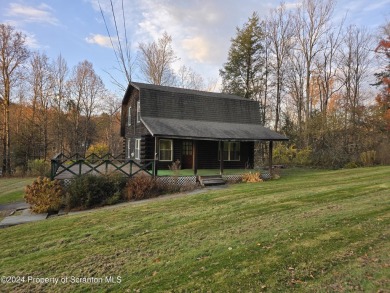 Check out this 3-bedroom, 1-bathroom log home! Featuring a cozy on Rock Creek Golf Course in Pennsylvania - for sale on GolfHomes.com, golf home, golf lot