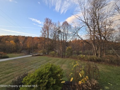 Check out this 3-bedroom, 1-bathroom log home! Featuring a cozy on Rock Creek Golf Course in Pennsylvania - for sale on GolfHomes.com, golf home, golf lot