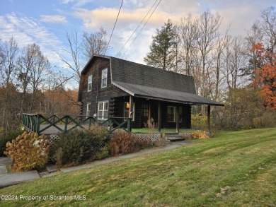 Check out this 3-bedroom, 1-bathroom log home! Featuring a cozy on Rock Creek Golf Course in Pennsylvania - for sale on GolfHomes.com, golf home, golf lot