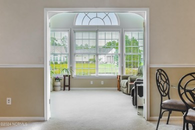 Discover this spacious 3-bedroom home with stunning pond views on Sandpiper Bay Golf and Country Club in North Carolina - for sale on GolfHomes.com, golf home, golf lot