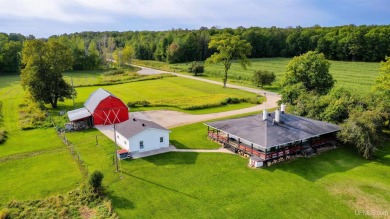 This picture perfect farmhouse sits nestled in the fields at the on Hiawatha Sportsmans Golf Club in Michigan - for sale on GolfHomes.com, golf home, golf lot