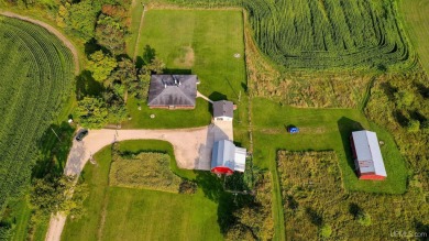 This picture perfect farmhouse sits nestled in the fields at the on Hiawatha Sportsmans Golf Club in Michigan - for sale on GolfHomes.com, golf home, golf lot