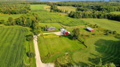 This picture perfect farmhouse sits nestled in the fields at the on Hiawatha Sportsmans Golf Club in Michigan - for sale on GolfHomes.com, golf home, golf lot