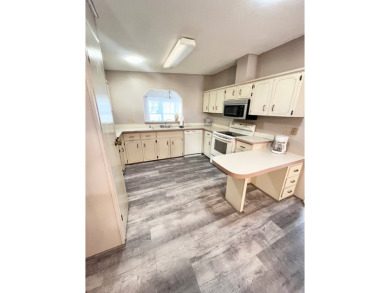 Looking for a well-maintained home in a vibrant gated golf on Pine Lakes Country Club in Florida - for sale on GolfHomes.com, golf home, golf lot