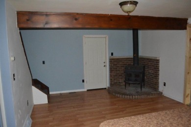 Discover the perfect retreat in this cozy chalet, ideally on Burning Oak Country Club in Michigan - for sale on GolfHomes.com, golf home, golf lot