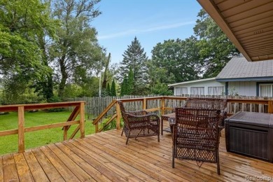 Discover the perfect blend of charm and comfort with this on Highland Hills Golf Course in Michigan - for sale on GolfHomes.com, golf home, golf lot