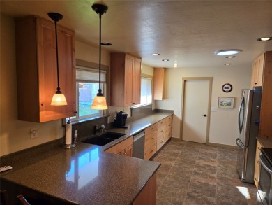 Charming one level ranch home conveniently located by the on Buffalo Hill Golf Club in Montana - for sale on GolfHomes.com, golf home, golf lot