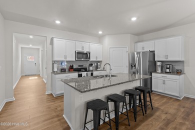 Nestled on a quiet cul-de-sac, this single-level four-bedroom on Harbour Point Golf Club in North Carolina - for sale on GolfHomes.com, golf home, golf lot