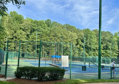 This exquisite brick townhome bathed in natural light overlooks on Lochmere Golf Club in North Carolina - for sale on GolfHomes.com, golf home, golf lot