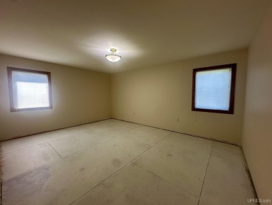 This home offers a rare opportunity to put your own finishing on Escanaba Country Club in Michigan - for sale on GolfHomes.com, golf home, golf lot