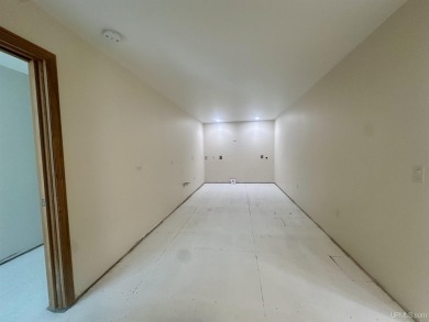 This home offers a rare opportunity to put your own finishing on Escanaba Country Club in Michigan - for sale on GolfHomes.com, golf home, golf lot