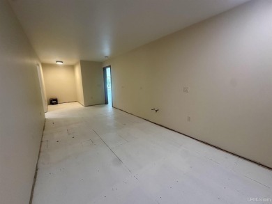 This home offers a rare opportunity to put your own finishing on Escanaba Country Club in Michigan - for sale on GolfHomes.com, golf home, golf lot